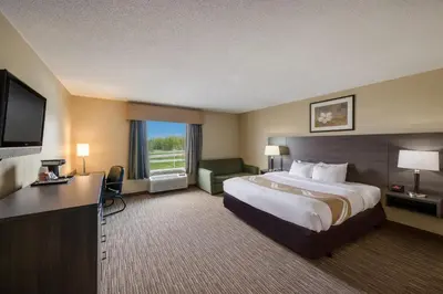 a hotel room with a large bed and a television at Quality Inn & Suites Fishkill South near I-84 in Fishkill
