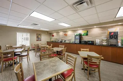 a restaurant with tables and chairs and a counter at Quality Inn & Suites Fishkill South near I-84 in Fishkill