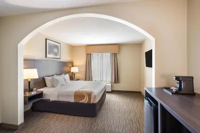 a hotel room with a bed and a window at Quality Inn & Suites Fishkill South near I-84 in Fishkill