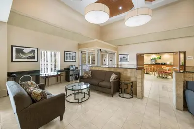 a large living room with couches and a kitchen at Quality Inn & Suites Fishkill South near I-84 in Fishkill