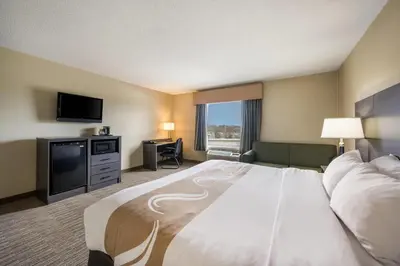 a hotel room with a large bed and a flat screen tv at Quality Inn & Suites Fishkill South near I-84 in Fishkill