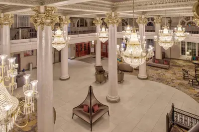 a large lobby with chandaliers and chandeliers at DoubleTree by Hilton Utica in Utica