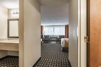 a hotel room with a bed and a bathroom at Quality Inn Schenectady - Albany in Schenectady