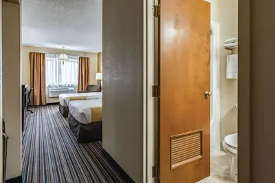 a hotel room with two beds and a bathroom at Quality Inn Schenectady - Albany in Schenectady