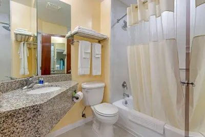 a bathroom with a toilet and a sink and a shower at Rodeway Inn & Suites New Paltz - Hudson Valley in New Paltz