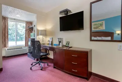 an office with a desk and a chair and a mirror at Rodeway Inn & Suites New Paltz - Hudson Valley in New Paltz