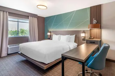 a hotel room with a bed and a desk at Comfort Inn & Suites Saratoga Springs in Saratoga Springs