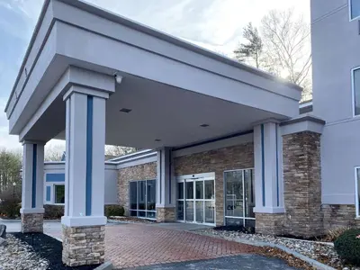 a large building with blue columns in front of it at Comfort Inn & Suites Saratoga Springs in Saratoga Springs