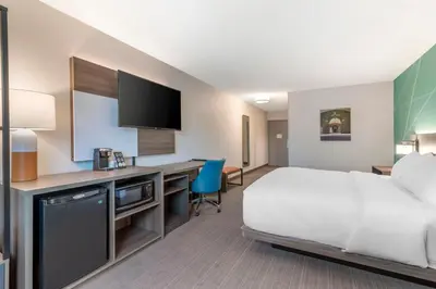 a hotel room with a bed and a desk at Comfort Inn & Suites Saratoga Springs in Saratoga Springs