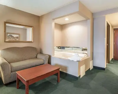 a living room with a couch and a tub at The Marx Hotel - Downtown - University Area in Oneonta