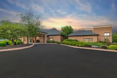 a house with a driveway in front of it at Comfort Inn Pocono Lakes Region in Lake Ariel