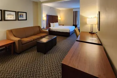 a hotel room with a bed and a couch at Comfort Inn & Suites Mount Pocono in Mount Pocono