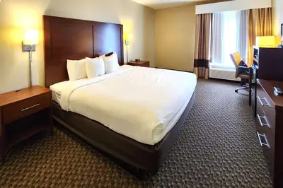 a hotel room with a large bed and a desk at Comfort Inn & Suites Mount Pocono in Mount Pocono