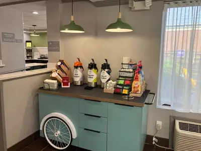 a counter with alcohol bottles on it in a kitchen at Spark by Hilton Clarks Summit in Clarks Summit