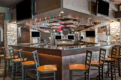 a bar with chairs and wine glasses at Baymont by Wyndham Bartonsville Poconos in Bartonsville