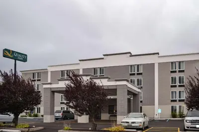 a large building with cars parked in a parking lot at Comfort Inn Dunmore - Scranton East in Dunmore