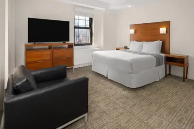 a hotel room with a bed and a television at The Beekman Tower, Trademark Collection by Wyndham in New York