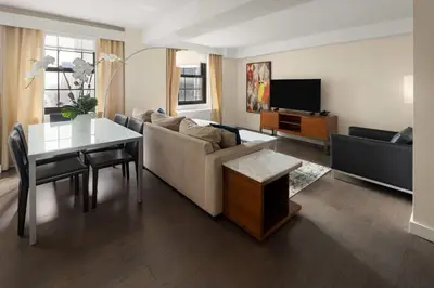a living room with a couch and a table at The Beekman Tower, Trademark Collection by Wyndham in New York