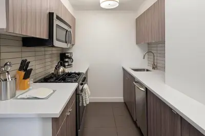 a kitchen with a stove and a microwave at The Beekman Tower, Trademark Collection by Wyndham in New York