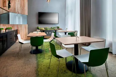 a restaurant with tables and chairs and a flat screen tv at SpringHill Suites by Marriott New York Midtown Manhattan/Fifth Avenue in New York