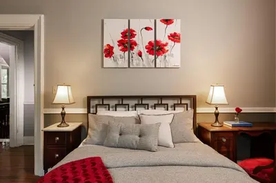 a bedroom with a bed with two night stands and two lamps at Rosemont Inn in Utica