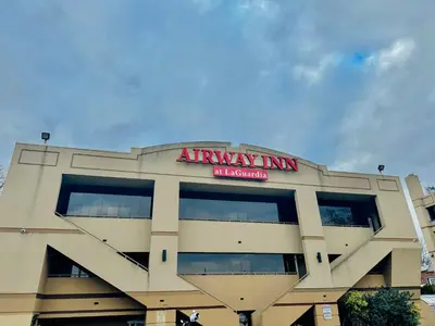 an apartment building with an airway inn sign on it at Airway Inn in Queens
