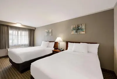 a hotel room with two beds and a window at SureStay Plus by Best Western Woodbury Inn in Woodbury