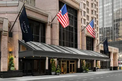 two american flags on the front of a building at The Luxury Collection Hotel Manhattan Midtown in New York