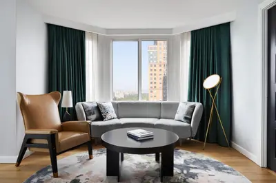 a living room with a couch and a table at The Luxury Collection Hotel Manhattan Midtown in New York