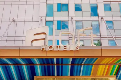 a hotel sign on the side of a building at Aloft New York LaGuardia Airport in Queens