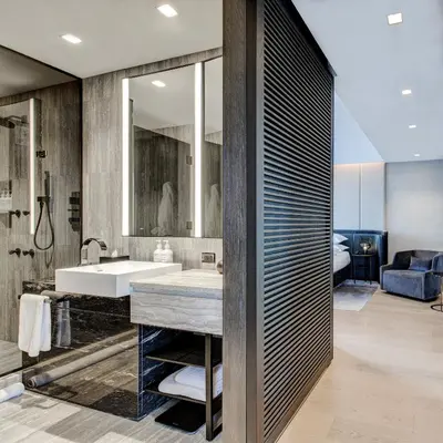 a bathroom with a sink and a large mirror at Equinox Hotel New York in New York