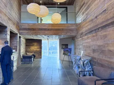a man standing in a room with wooden walls at The Watershed Norwalk in Norwalk