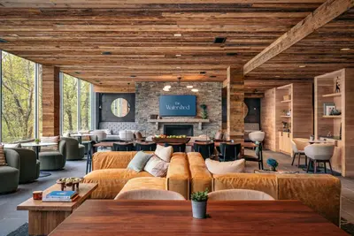 a living room with couches and a fireplace at The Watershed Norwalk in Norwalk