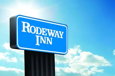 a blue roadeway limit sign on a pole at Rodeway Inn Little Falls in Little Falls