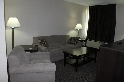 a living room with a couch and a table at Rodeway Inn Little Falls in Little Falls