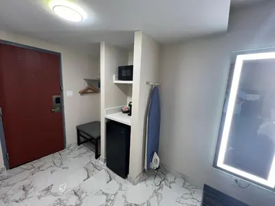 a room with a bathroom with a counter and a door at Rodeway Inn Little Falls in Little Falls