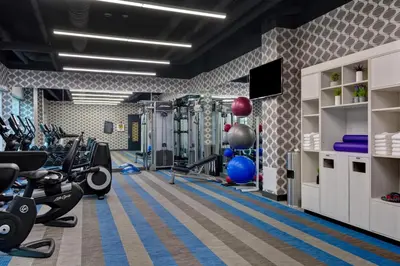 a gym with treadmills and cardio equipment in a room at Aloft Secaucus Meadowlands in Secaucus