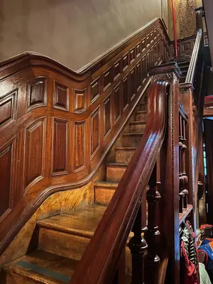 a wooden staircase in a house with wooden walls at Soul Food 'Mont Morris' in New York