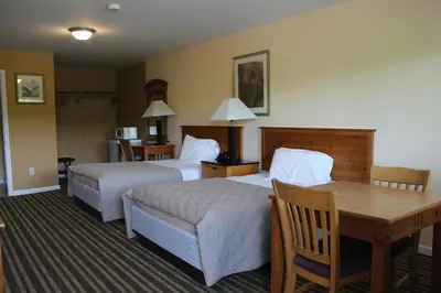 a hotel room with two beds and a table at Berkshire Travel Lodge in Canaan