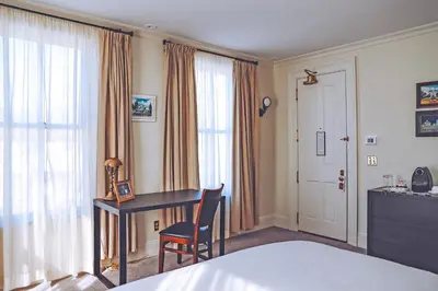 a hotel room with a desk and a bed at Hotel Fauchere in Milford