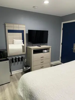 a bedroom with a bed and a flat screen tv at Dunmore Inn in Dunmore