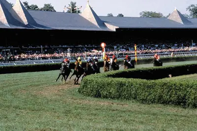a group of horses racing on a race track at Robin Hood Motel in Saratoga Springs
