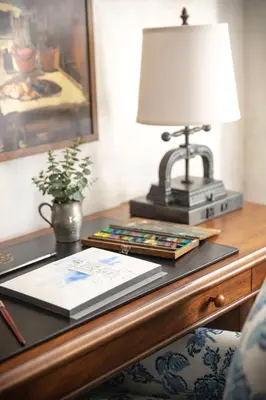 a desk with a lamp and a book on it at Graduate by Hilton New Haven in New Haven