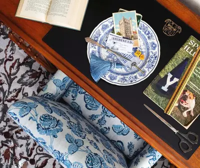 a table with a plate and a book and a chair at Graduate by Hilton New Haven in New Haven