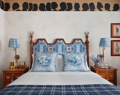 a bed with blue and white pillows on it at Graduate by Hilton New Haven in New Haven