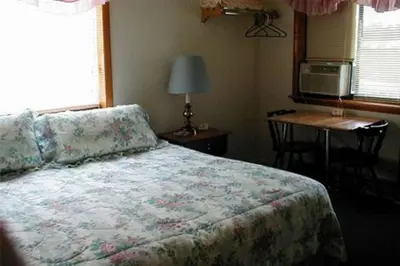 a bedroom with a bed and a table and a desk at Jenny's Country Manor in Stanfordville