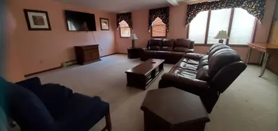a living room with leather couches and a tv at Red Ranch Inn in Catskill