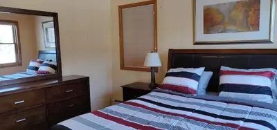 a bedroom with a bed and a large mirror at Red Ranch Inn in Catskill