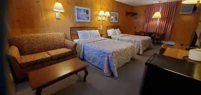 a hotel room with two beds and a couch at Red Ranch Inn in Catskill