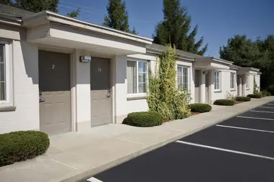 a row of garages in a parking lot at Americas Best Value Inn Greenbush Albany in East Greenbush